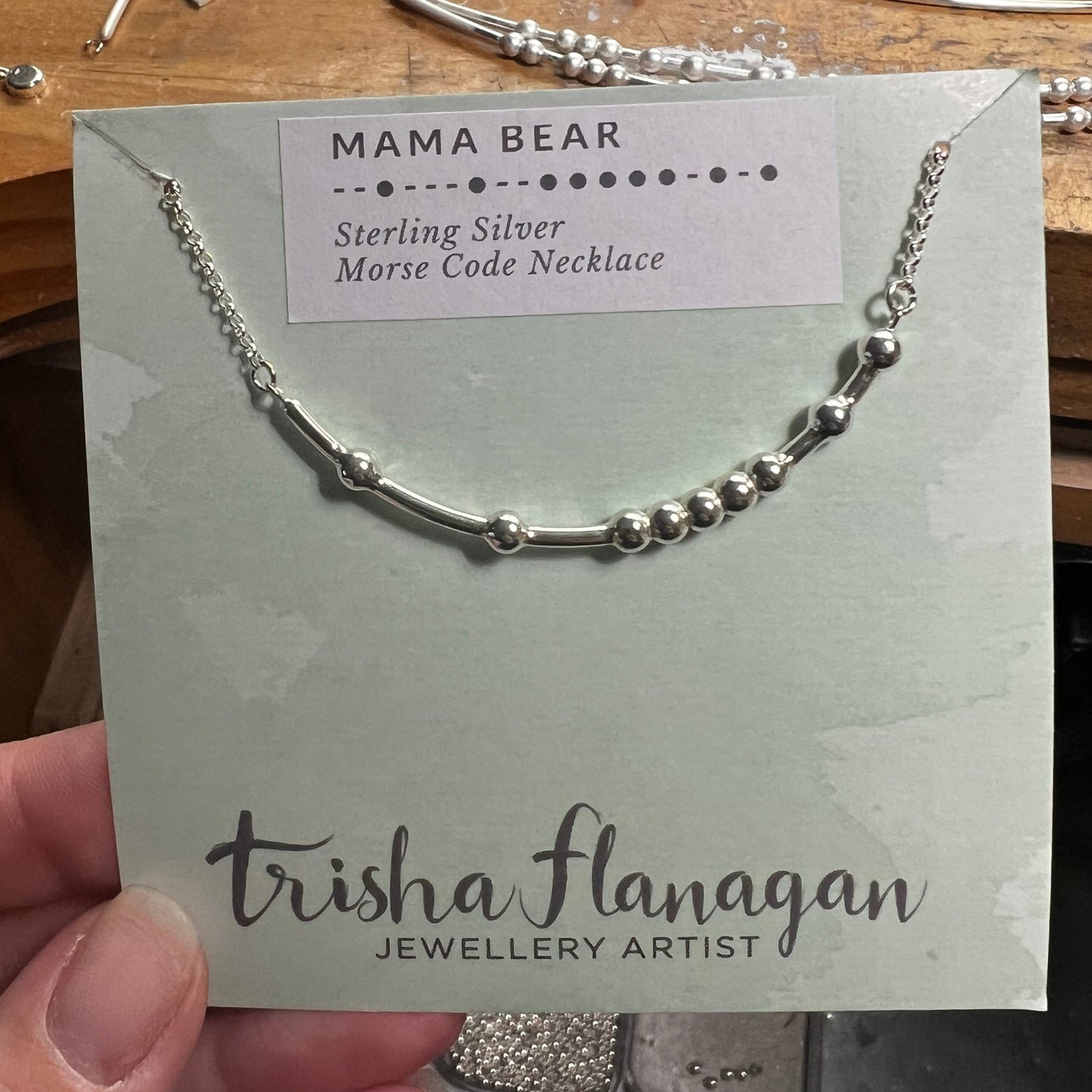 Mama Bear Morse Code Necklace on a display card