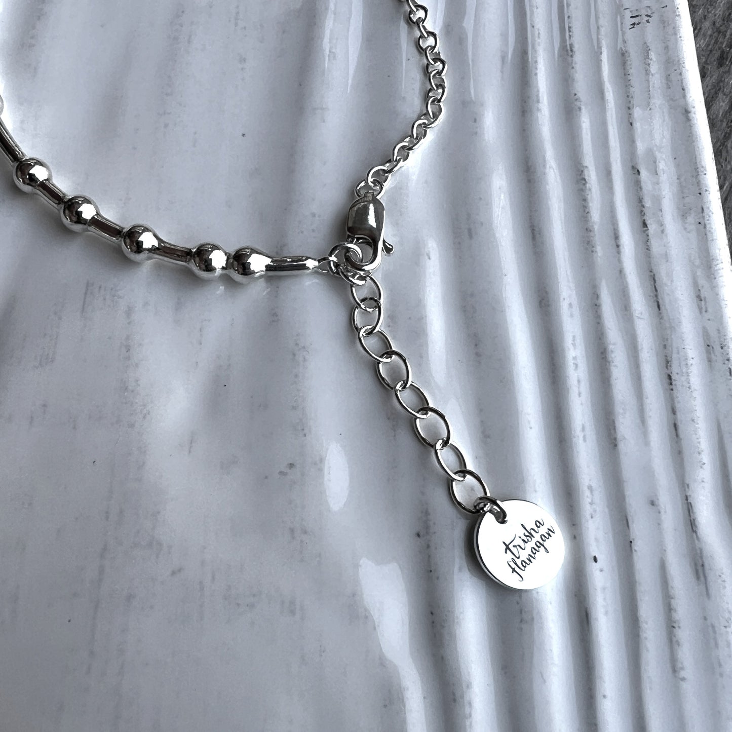 Inch extender chain with logo charm