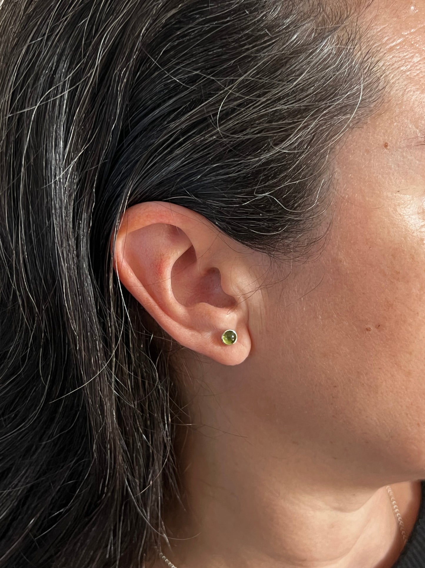 For size reference Woman Wearing the same size Peridot Stud Earring
