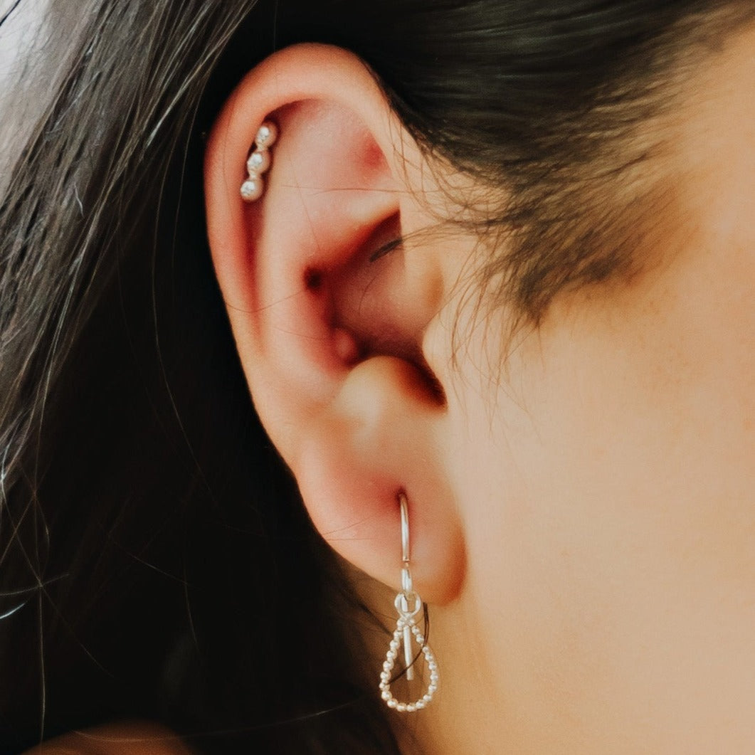 Woman wearing Sterling Silver Triple Dot Line Stud Earrings - Trisha Flanagan