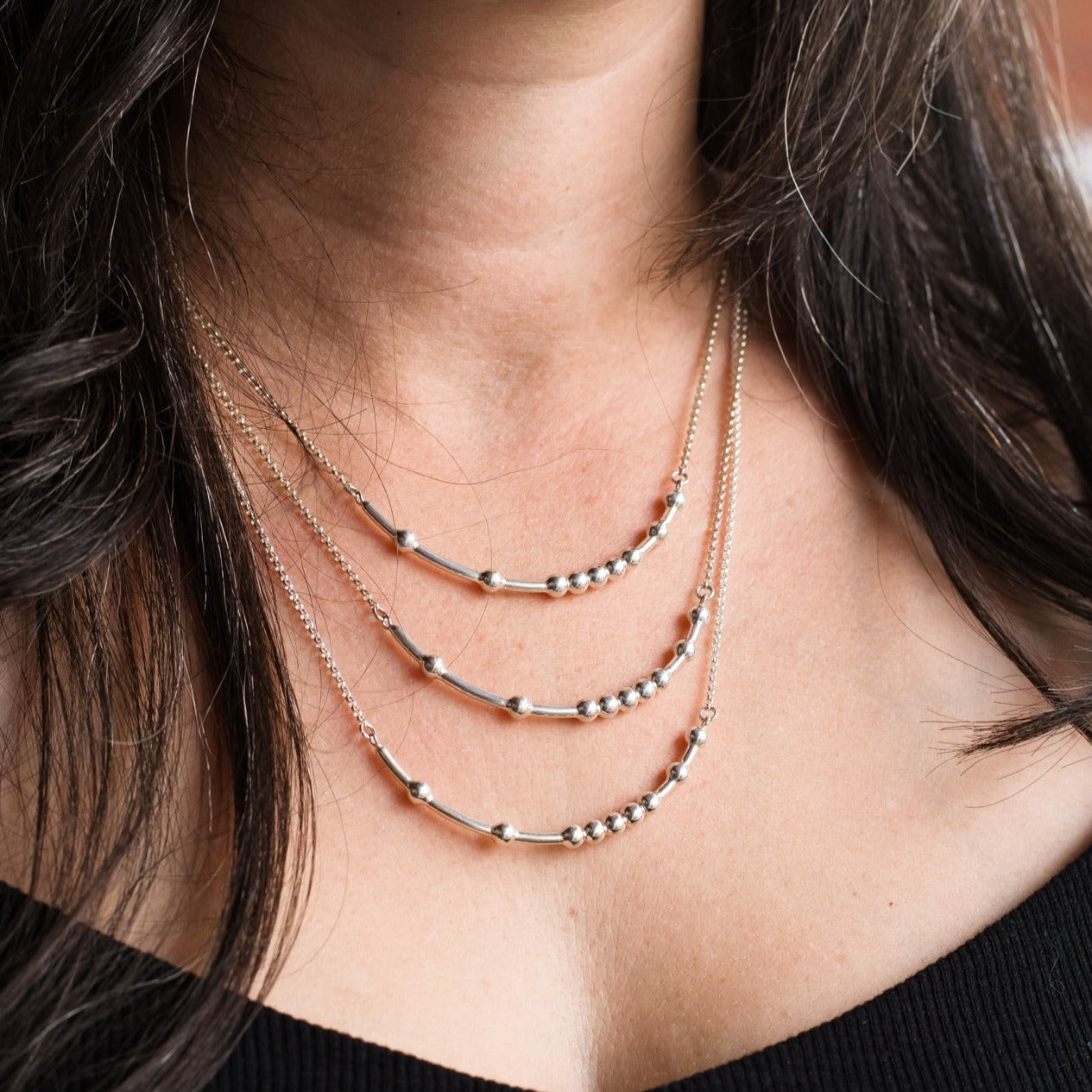 Woman wearing three sizes of chain - Trisha Flanagan