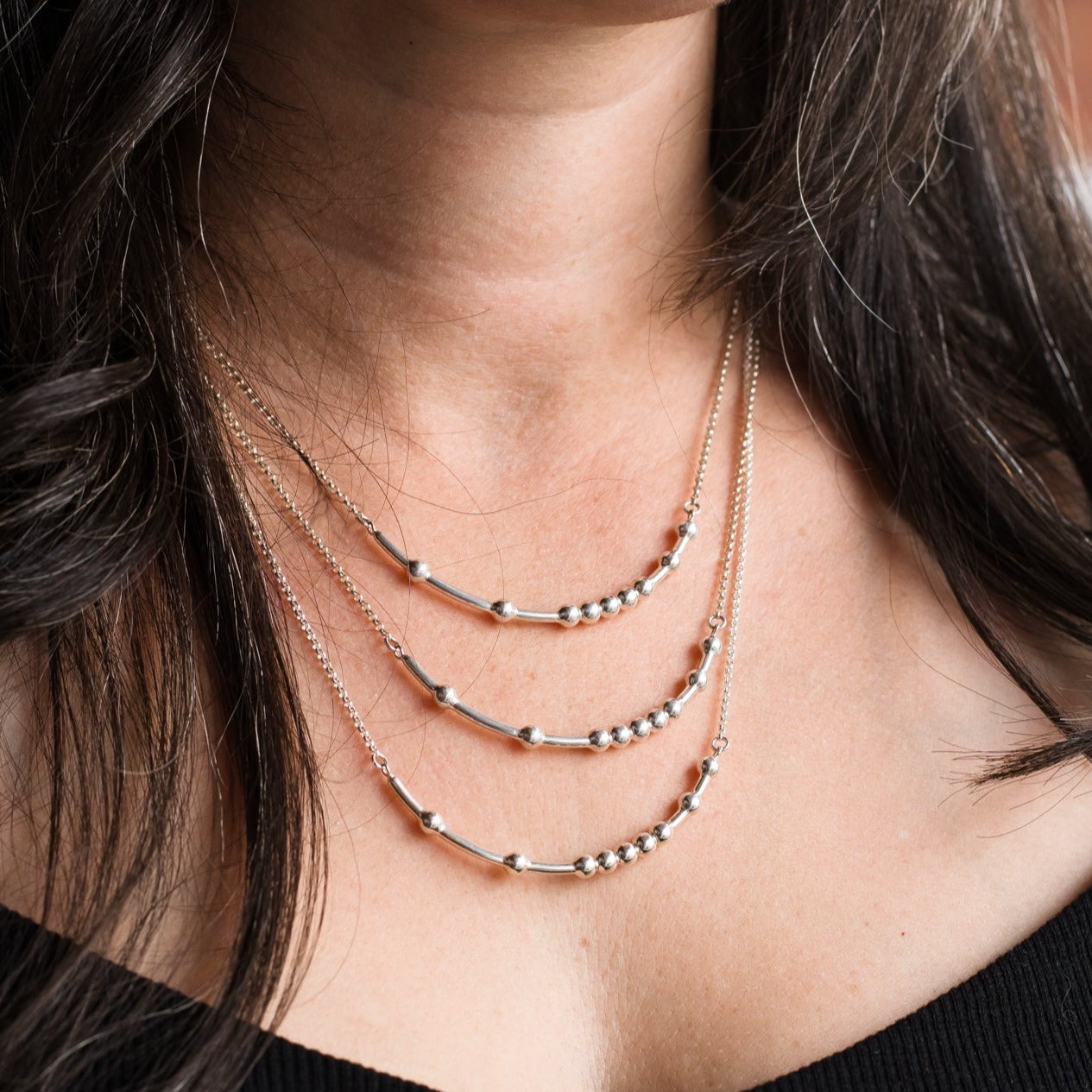 Woman wearing three sizes of chain - Trisha Flanagan