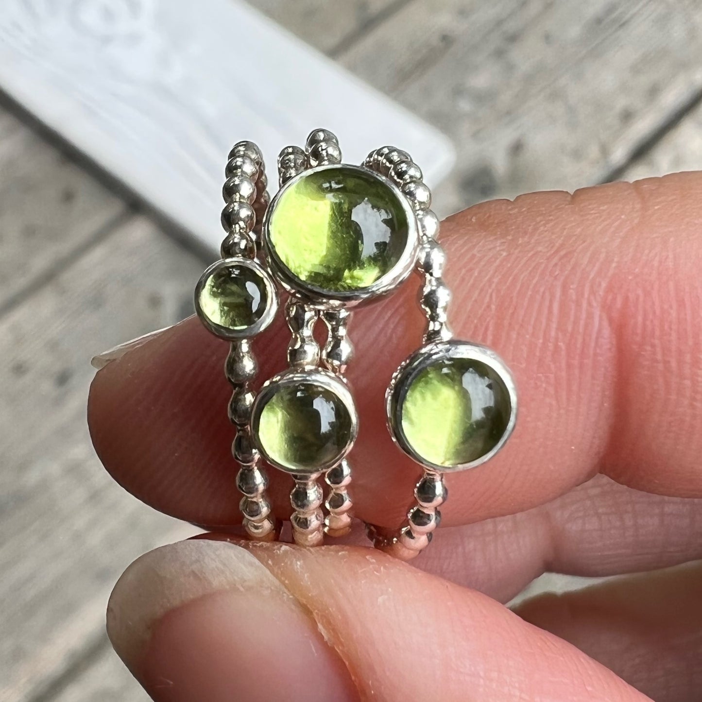 Holding different size Peridot Stacking Ring - Trisha Flanagan