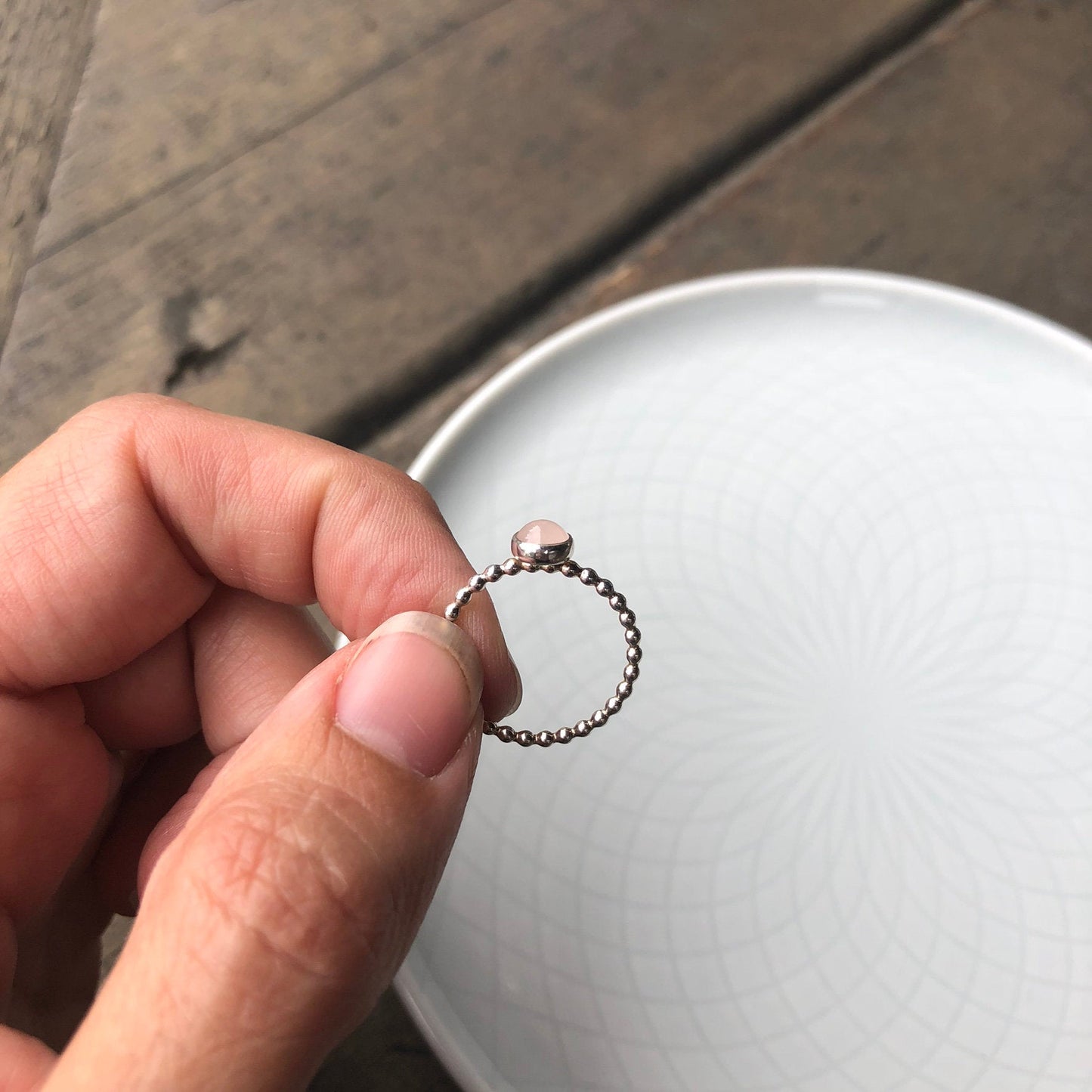 Woman holding a Medium Rose Quartz Silver Ring side view - Trisha Flanagan
