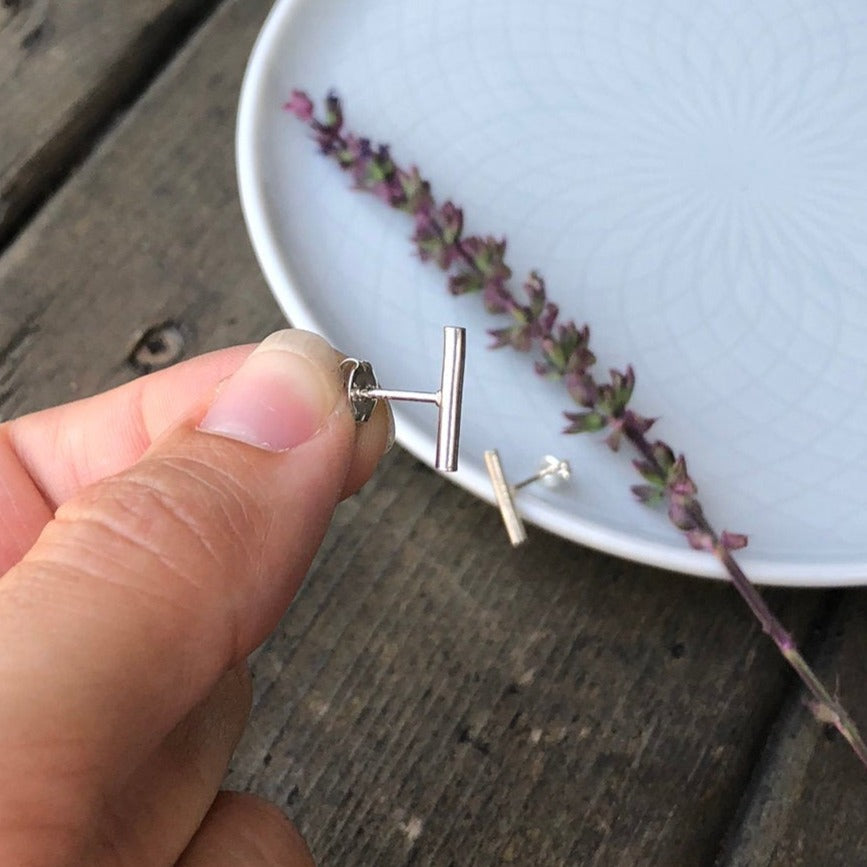 Woman holding a Silver Bar Stud side view - Trisha Flanagan