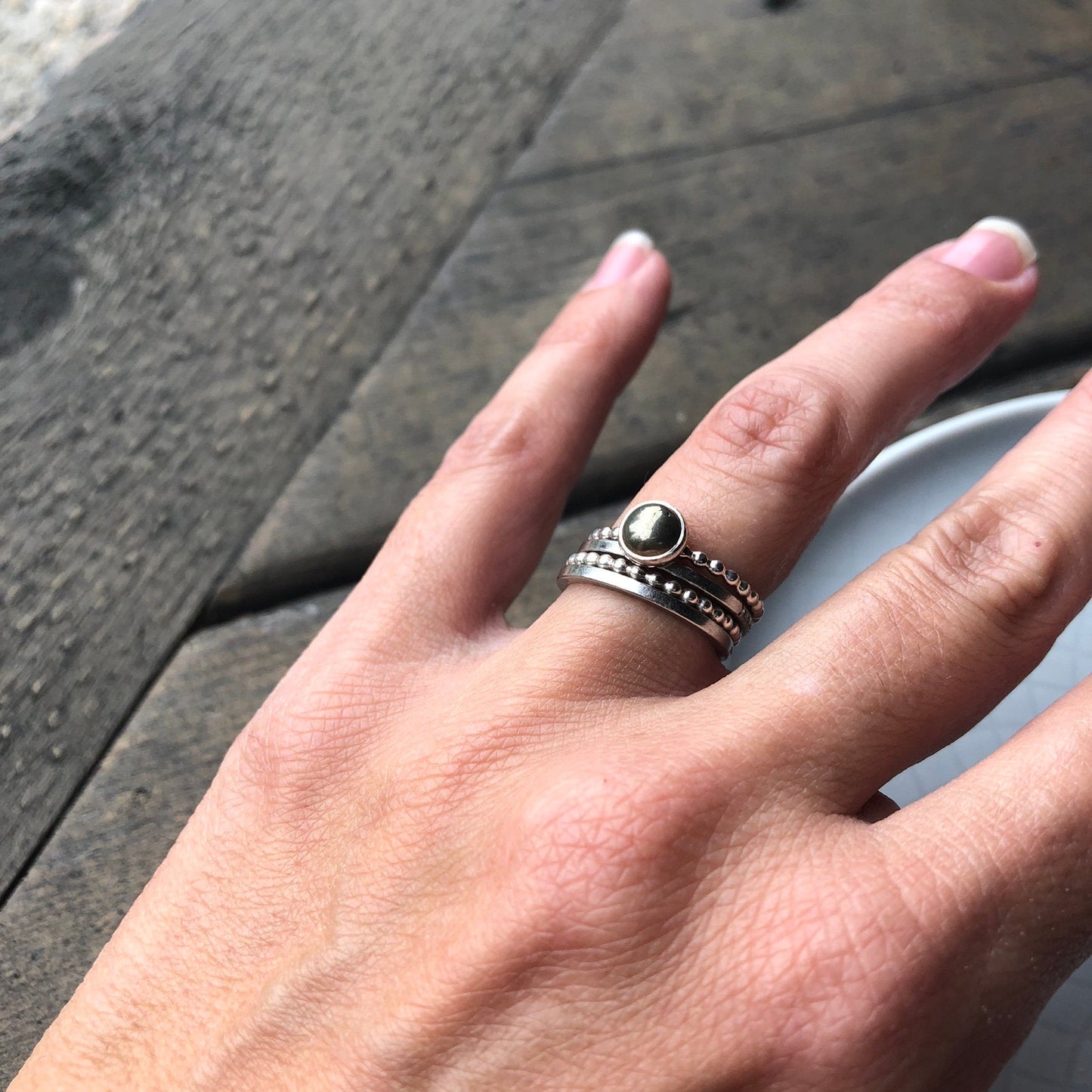 Woman wearing Large Pyrite Silver Ring with silver band rings- Trisha Flanagan