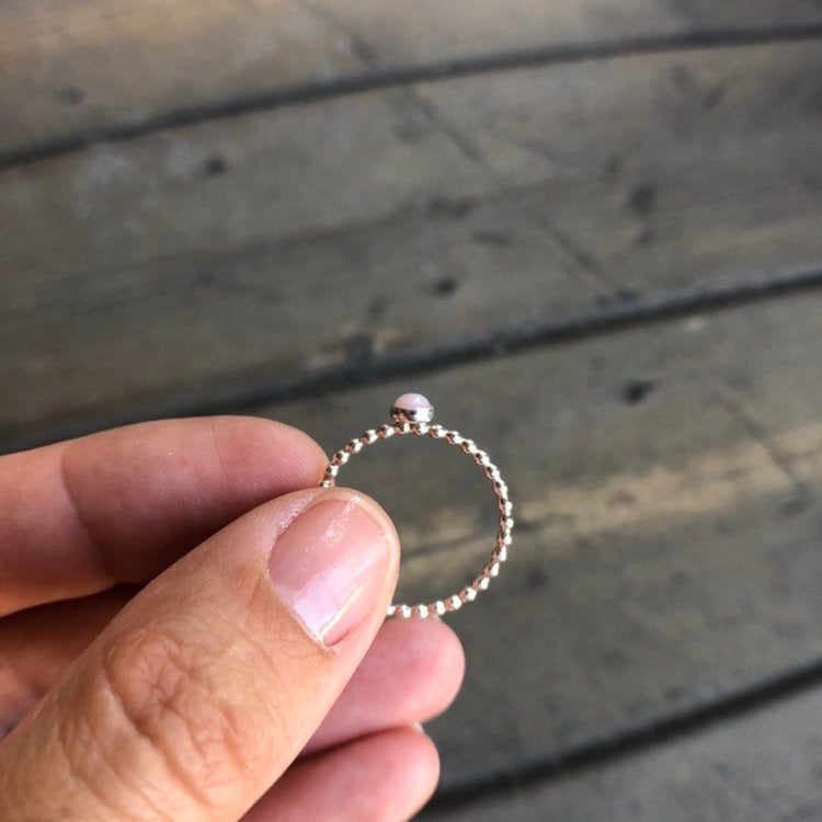 Woman holding a Small Pink Opal Sterling Silver Ring side view - Trisha Flanagan