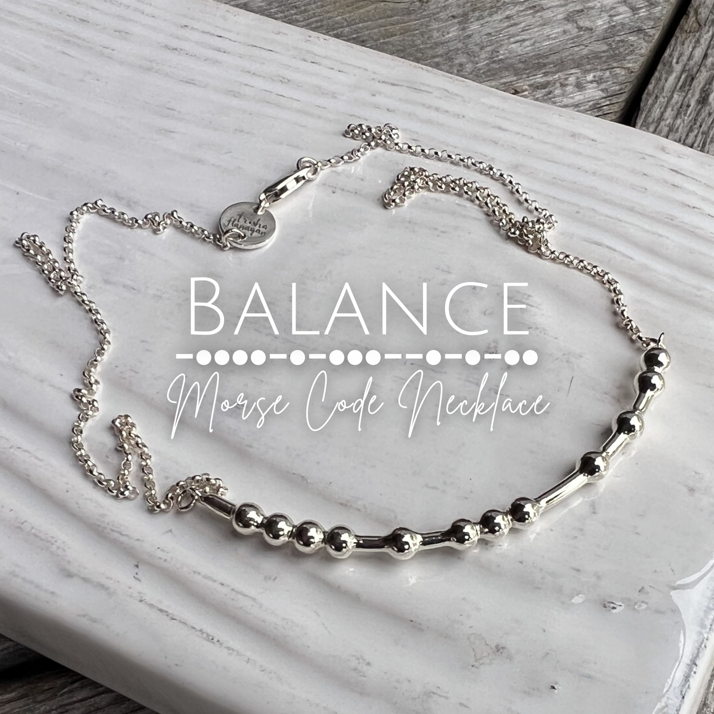 Silver 'Balance Morse Code Necklace' on a marble surface