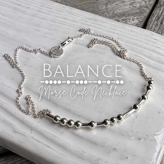 Silver 'Balance Morse Code Necklace' on a marble surface
