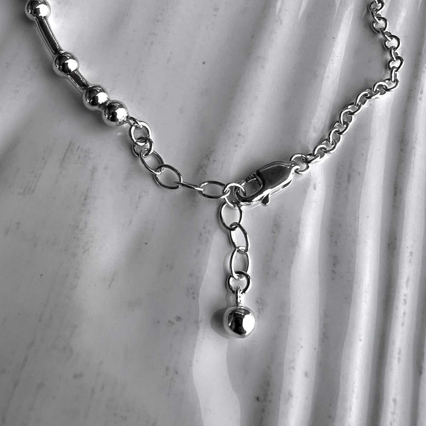 An inch extender chain with bauble charm