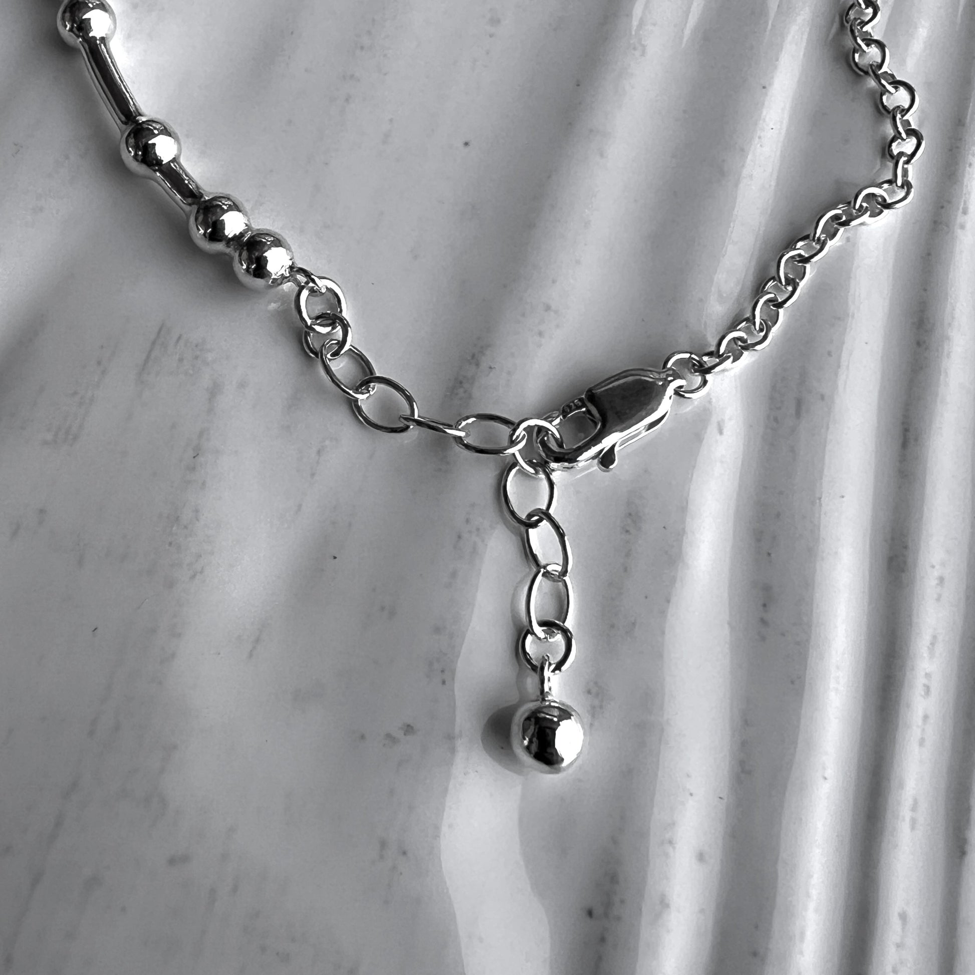 An inch extender chain with bauble charm