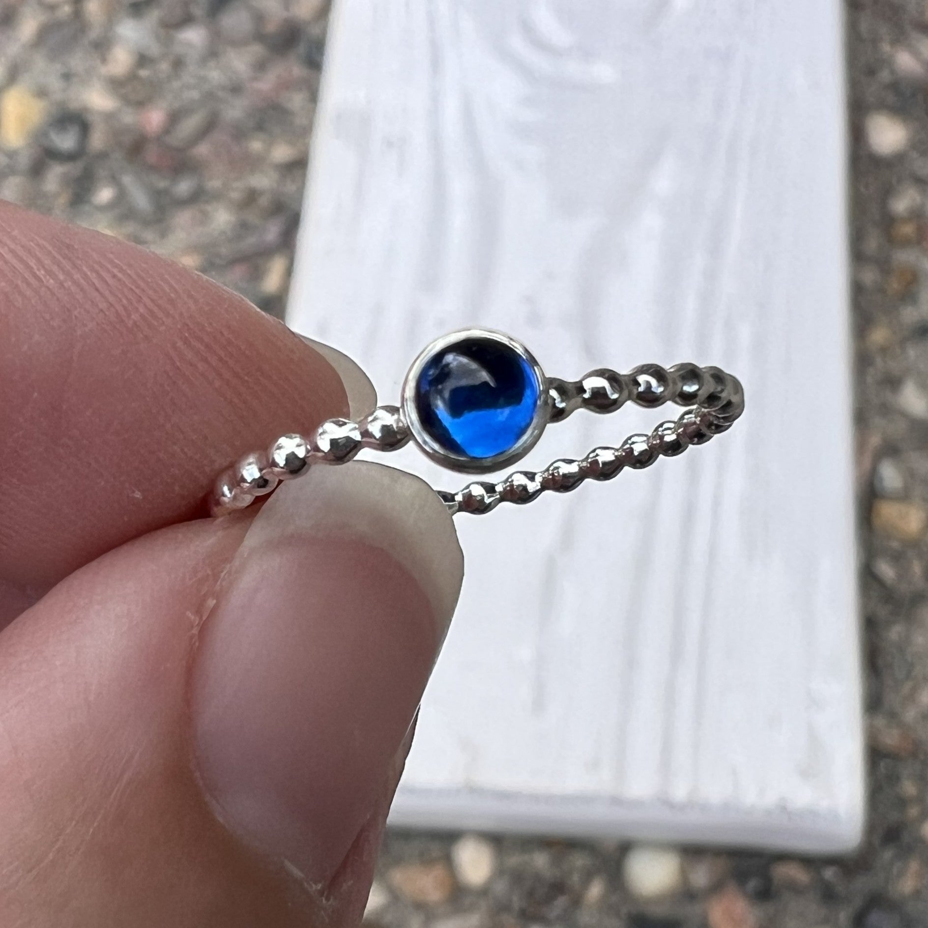 Holding a 4mm Small Lab Sapphire Ring