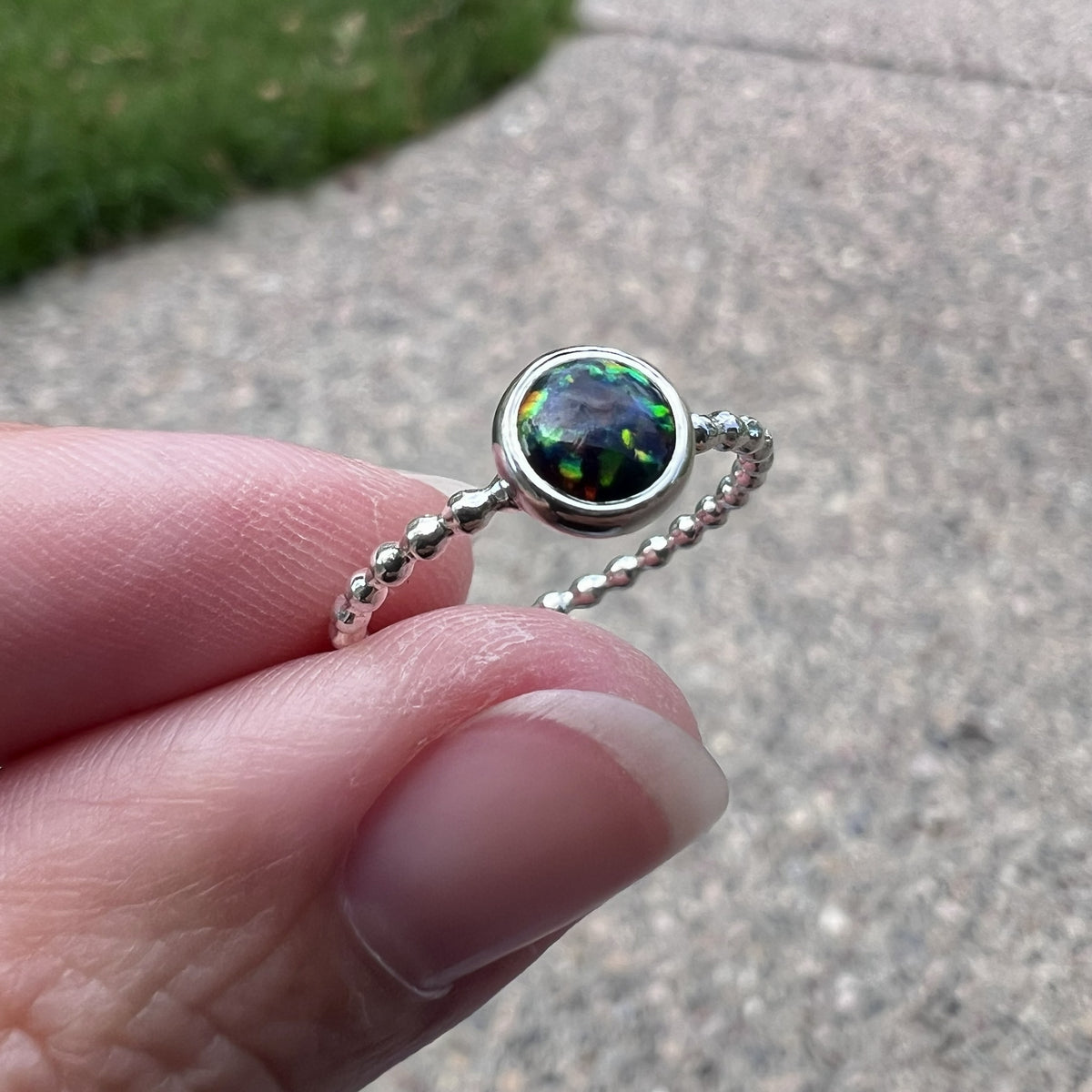 Holding a 6mm Black Opal Stacking Ring