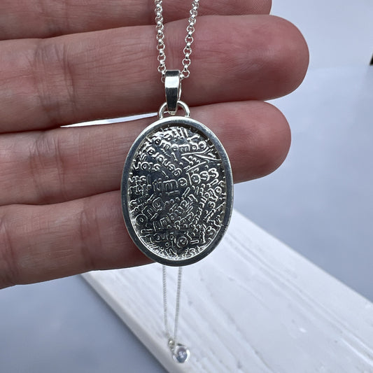 Holding the Wordsmith Pendant