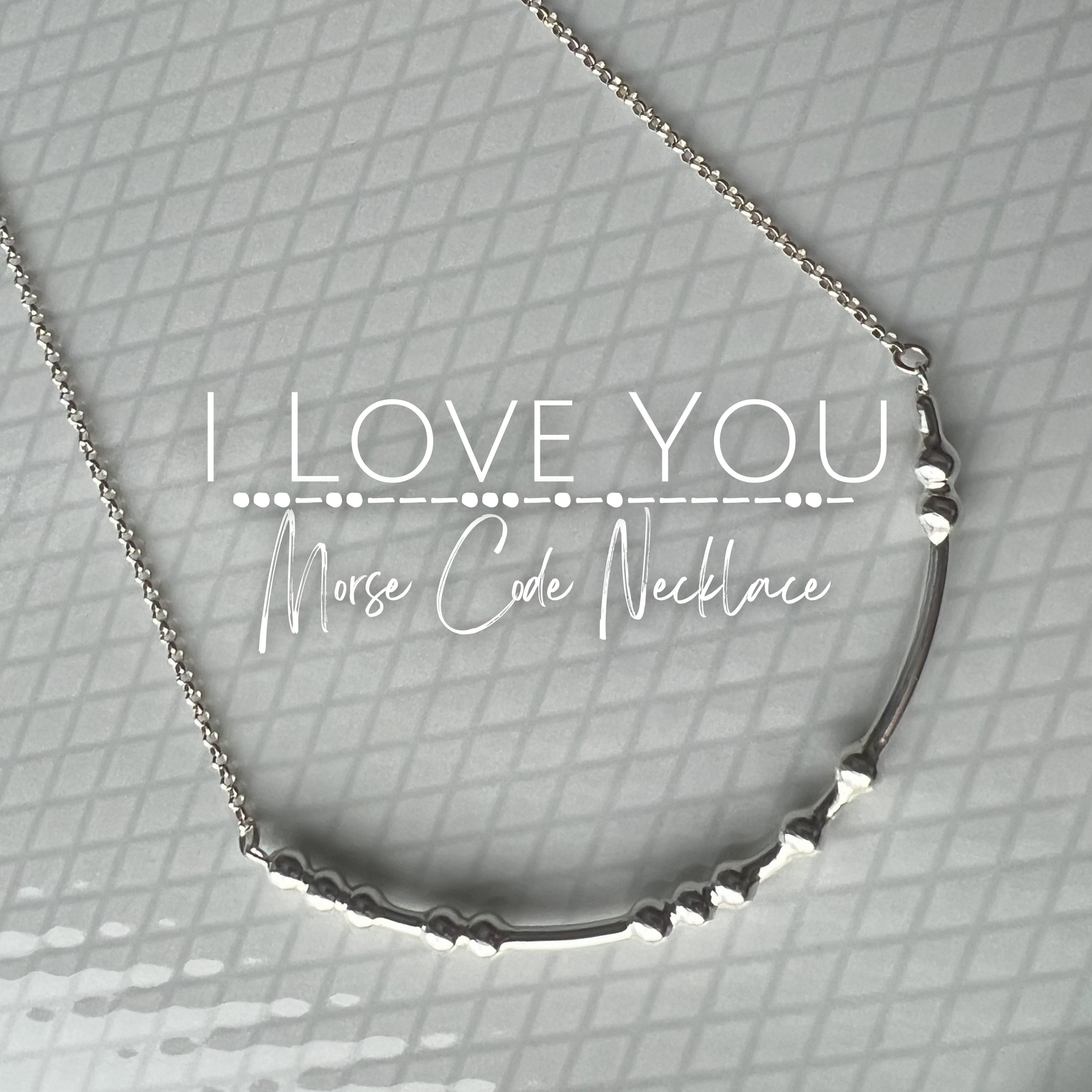 I Love You Morse Code Necklace laying on a plate