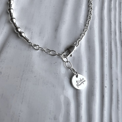 An inch extender chain with bauble charm