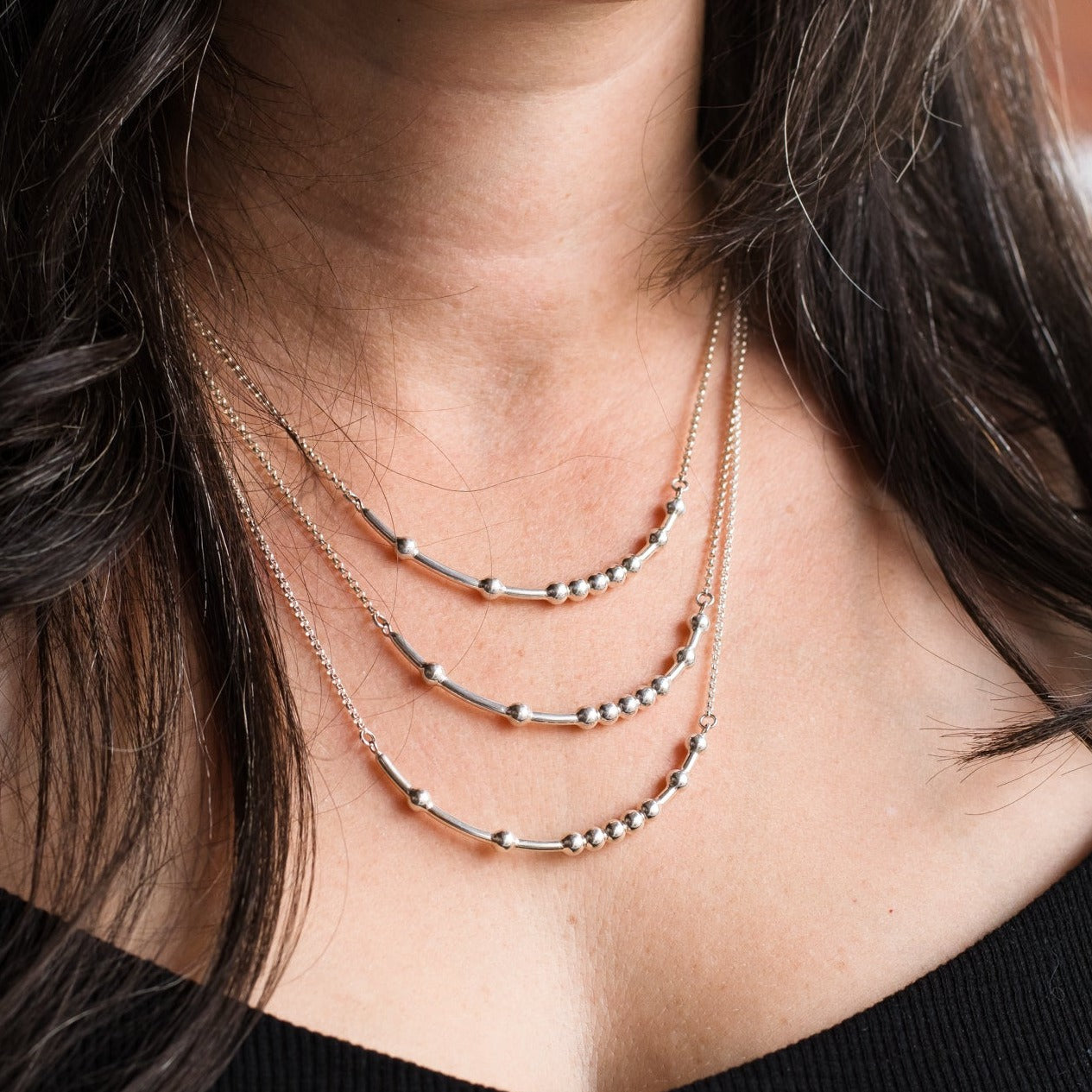 Woman wearing three sizes of chain - Trisha Flanagan