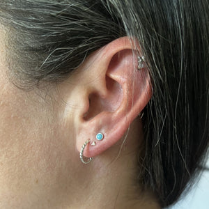 Wearing a combo of turquoise and silver earrings