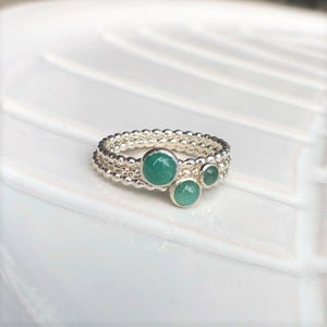 Different Emerald Rings stacked - Trisha Flanagan