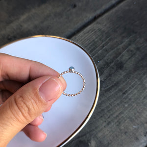 Woman holding a Mini Aquamarine Silver Ring side view - Trisha Flanagan