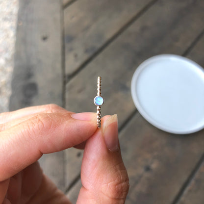 Woman holding a Mini Blue Manmade Simulated Opal Stacking Ring - Trisha Flanagan