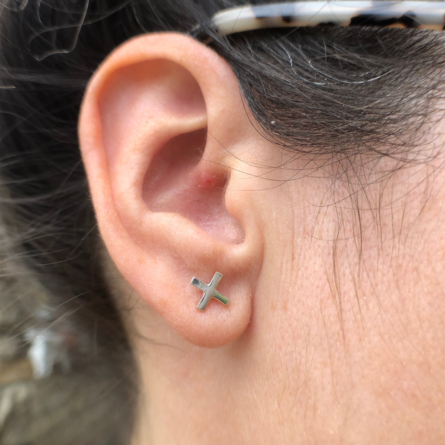 Woman wearing the x of the XO Silver Mismatched Earring Studs - Trisha Flanagan