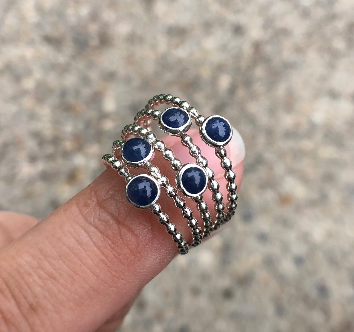 Woman holding several Small Sapphire Silver Stacking Rings - Trisha Flanagan