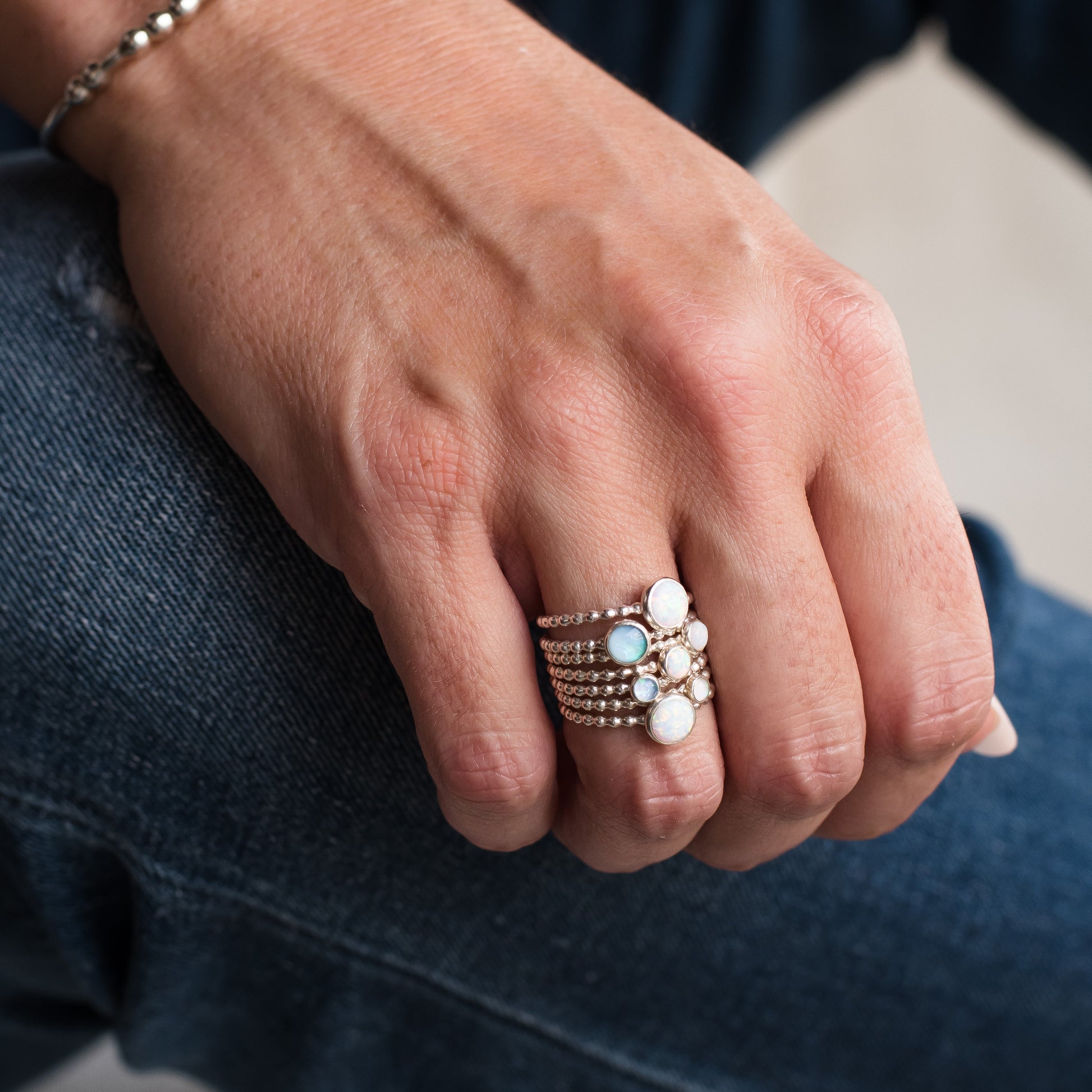 Woman wearing different Opal Birthstone Silver Rings - Trisha Flanagan