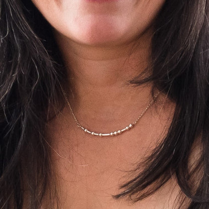 Woman wearing a silver FUCK Morse Code Necklace