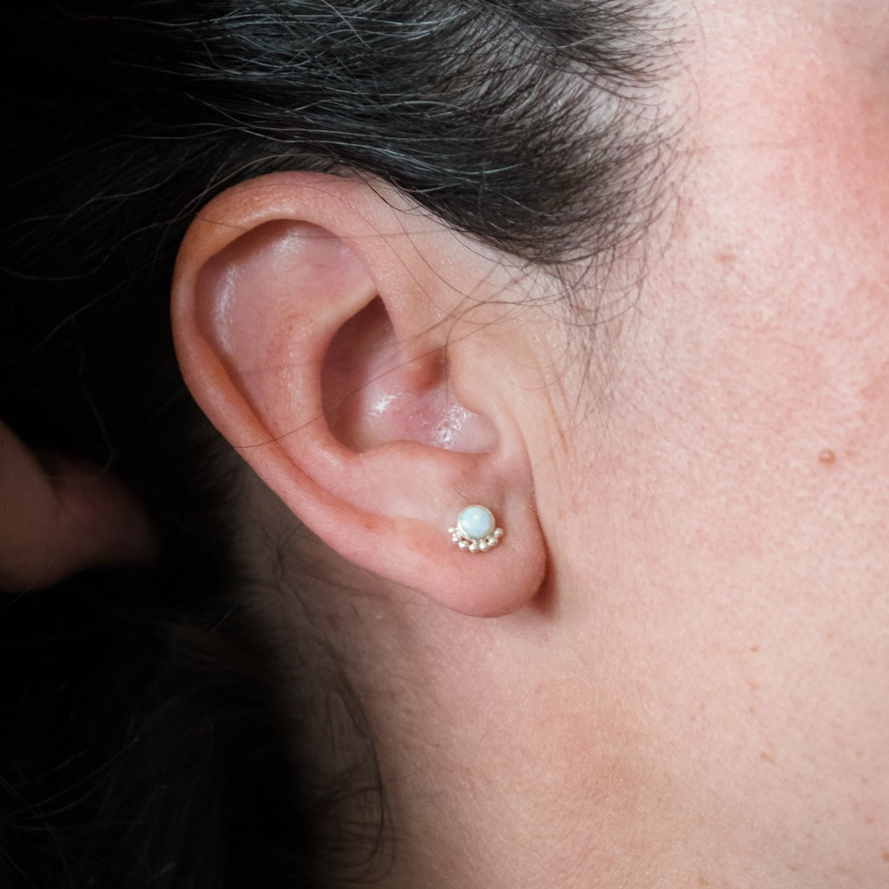 Woman wearing a gemstone Eyelash Stud Earring close up - Trisha Flanagan