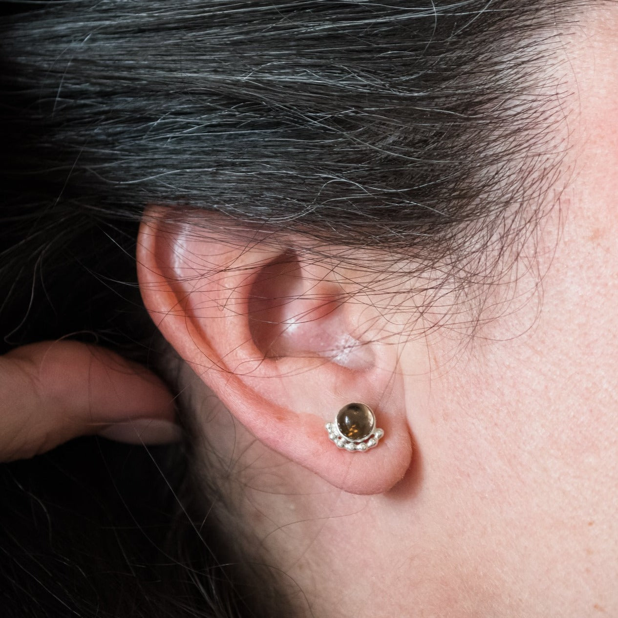 Woman wearing a Large gemstone Eyelash stud earring close up - Trisha Flanagan