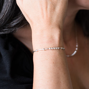 Woman wearing MAMA BEAR Morse Code Bracelet 