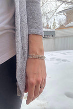 Load image into Gallery viewer, Woman wearing three silver Morse Code Bracelets in the winter