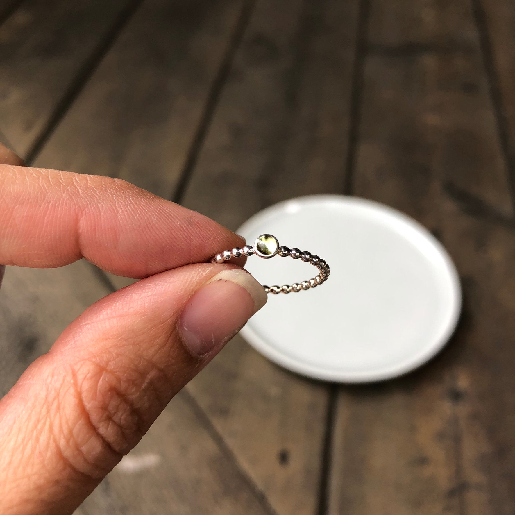 Woman wearing a Mini Peridot Silver Stacking Ring - Trisha Flanagan