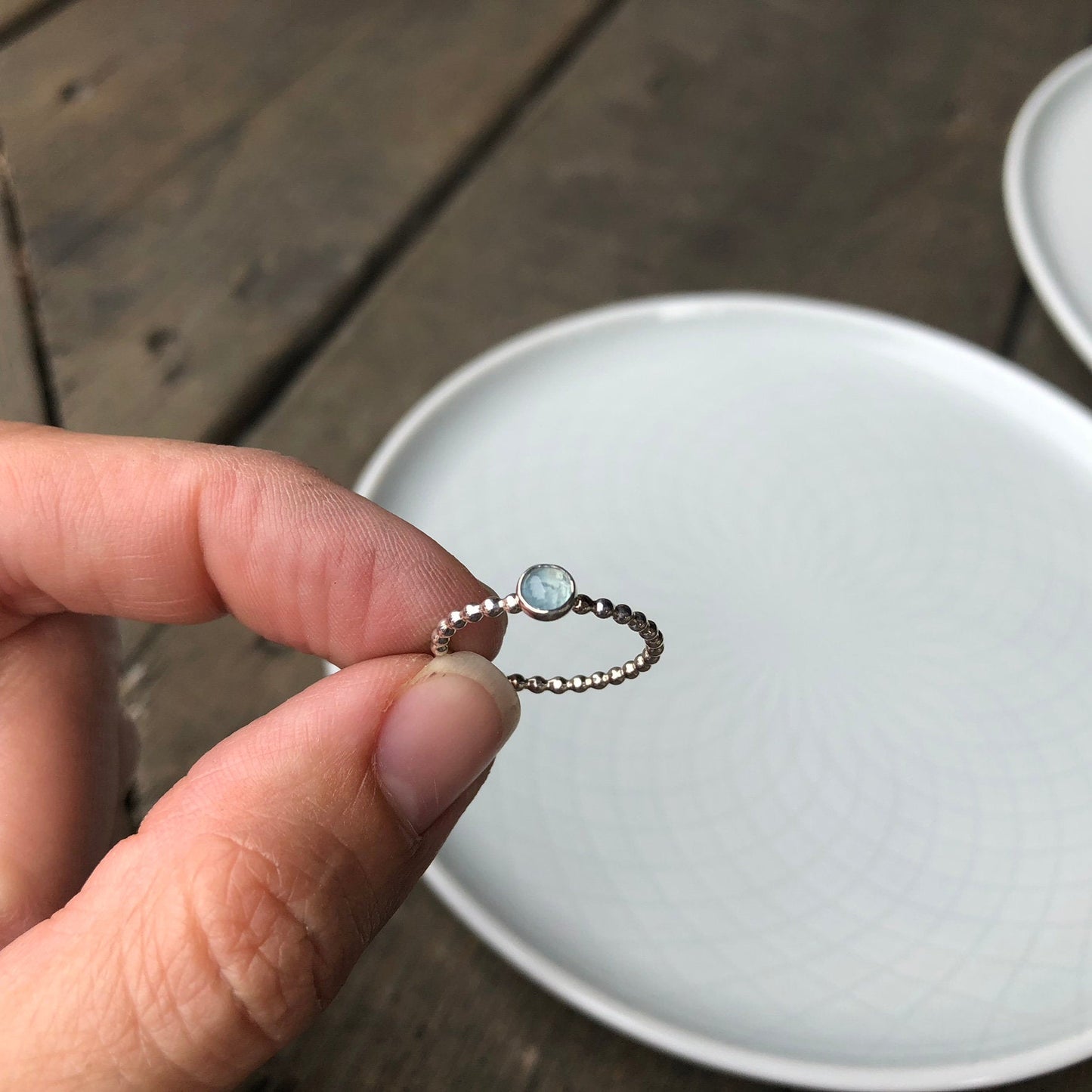 Woman holding a Small Aquamarine Silver Ring - Trisha Flanagan