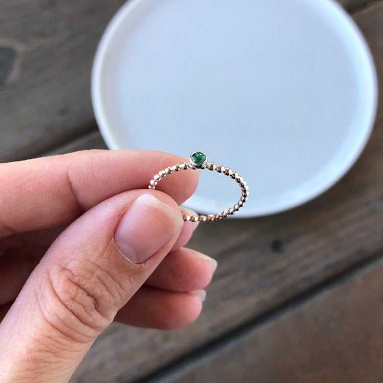 Woman holding a Mini Emerald Silver Stacking Ring - Trisha Flanagan