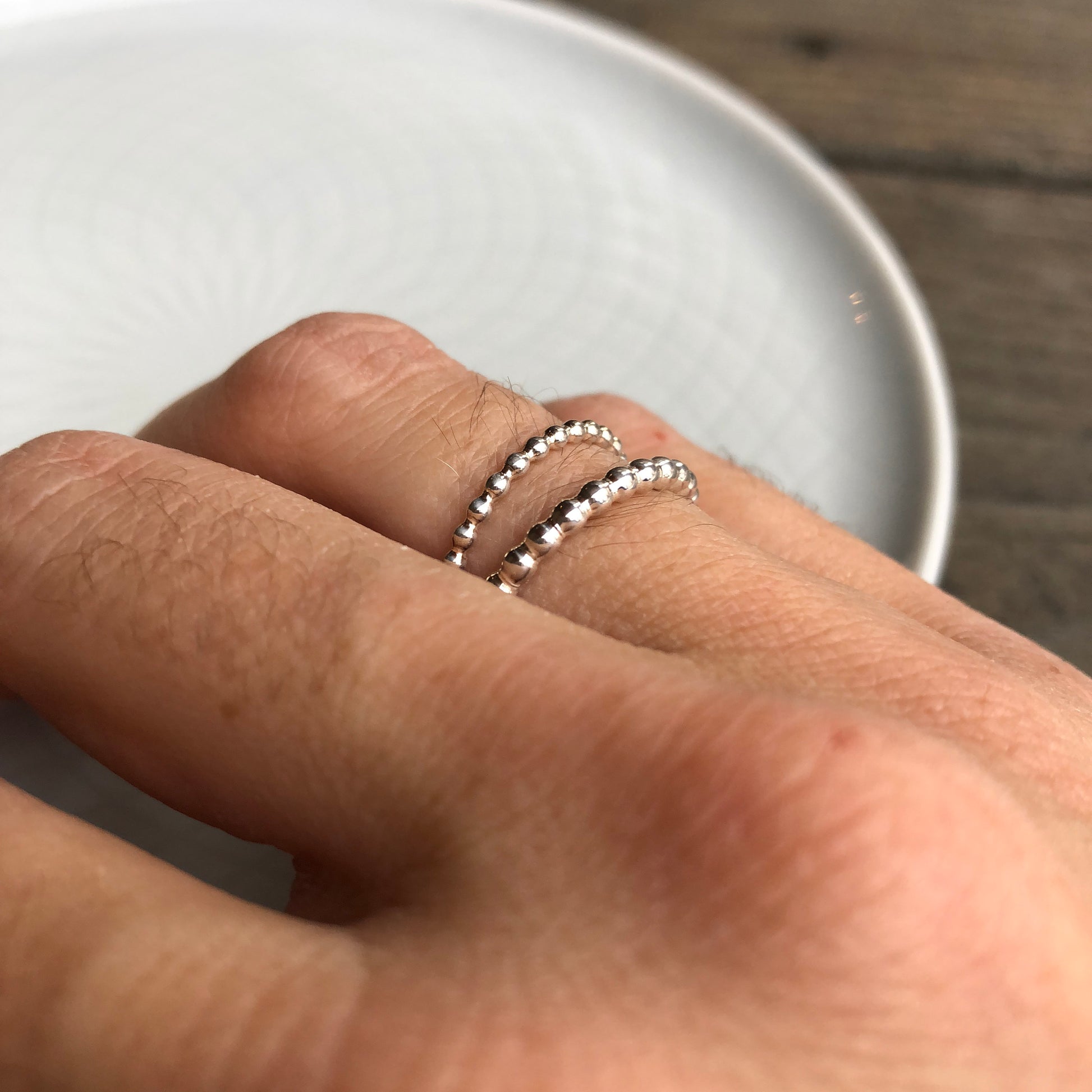 Woman wearing different size Sterling Silver Beaded Band Rings - Trisha Flanagan