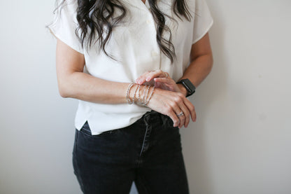 Woman wearing several Morse Code bracelets