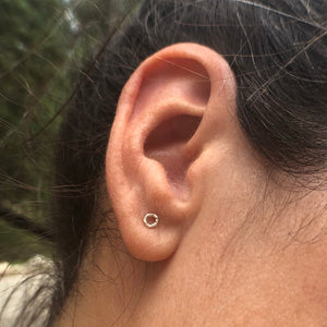 Woman wearing a Micro Textured Circle Studs Earring - Trisha Flanagan